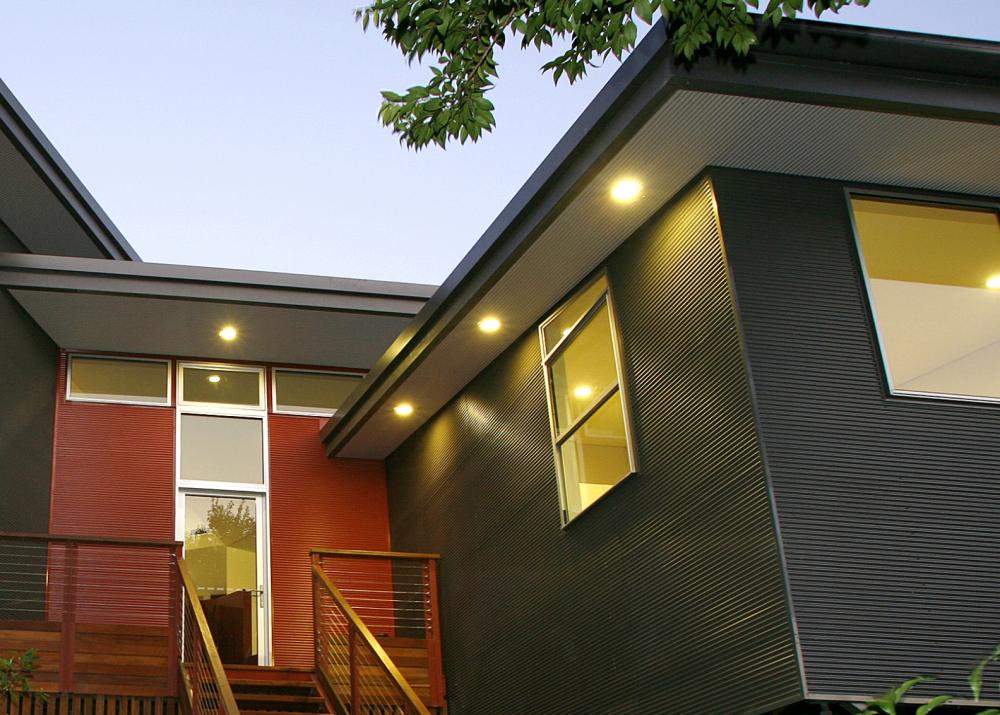 House with MINI ORB steel walling manufactured from COLORBOND steel in colours Woodland Grey and Manor Red