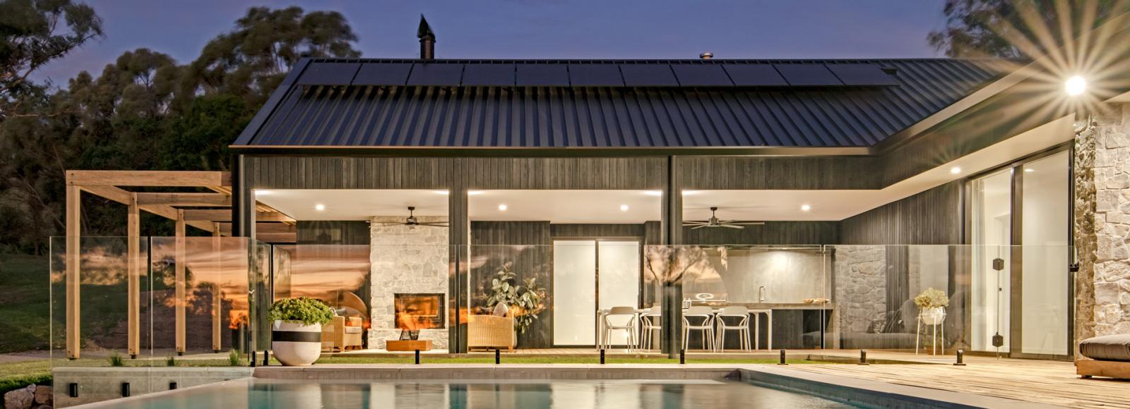 Wide view of a modern home with Lysaght COLORBOND® steel roofing sheets in a dark grey roof colour