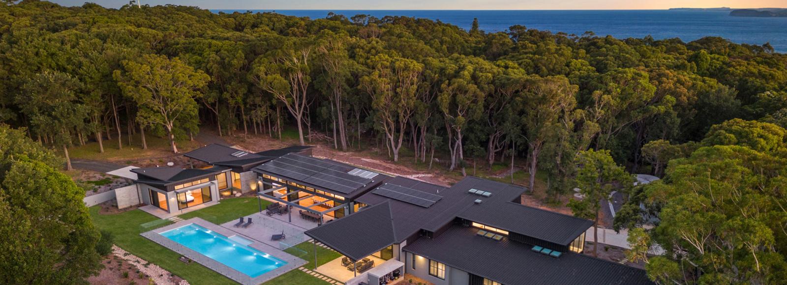 Contemporary coastal home with steel cyclone roofing designed for high wind regions