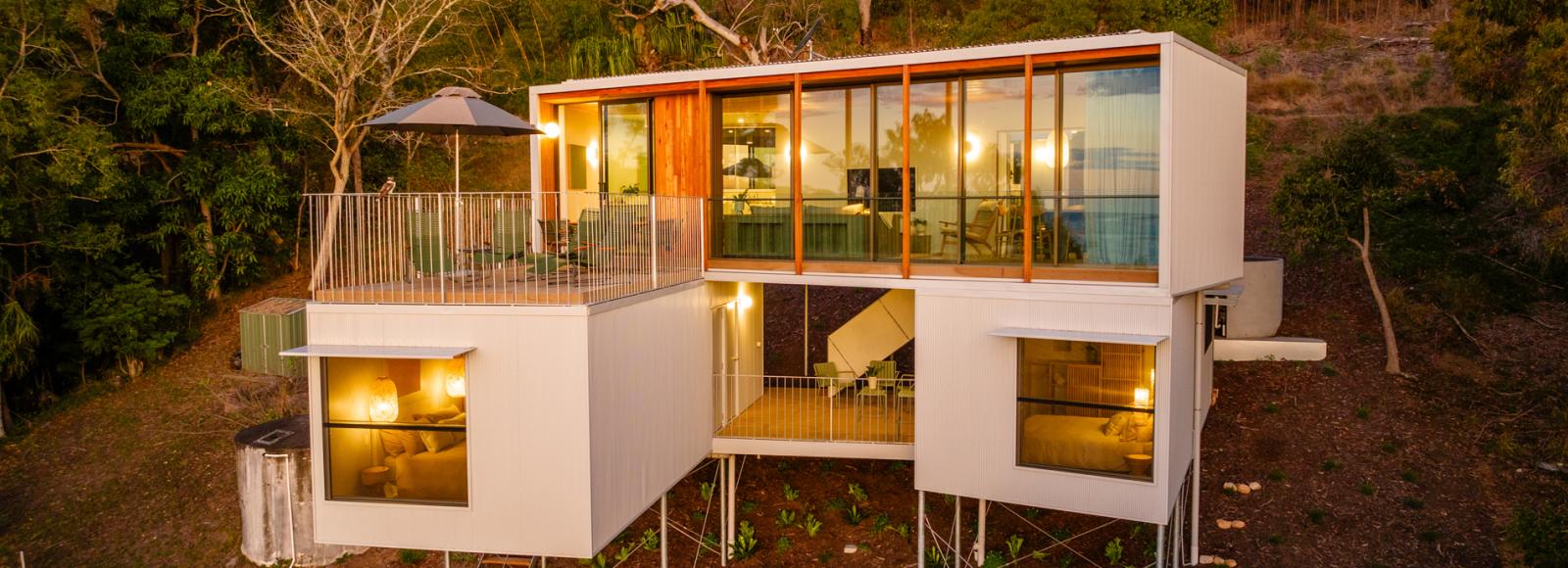 Modern home exterior with wall cladding, showing MINI ORB® cladding used as a subtle feature wall across elevated volumes.
