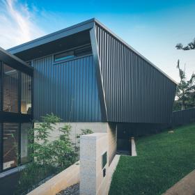 House with LONGLINE 305 walling  manufactured from COLORBOND steel in colour Monument