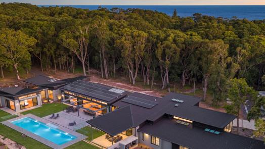 Contemporary coastal home with steel cyclone roofing designed for high wind regions