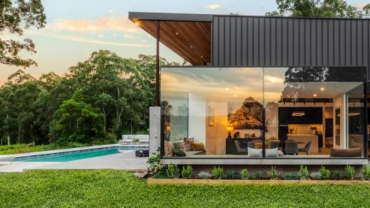 Modern home featuring LYSAGHT ENSEAM® cladding for a clean, modern facade beside a pool.