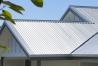 Gable roof with steel sheets and neatly detailed flashings designed for effective weatherproofing roof edges.