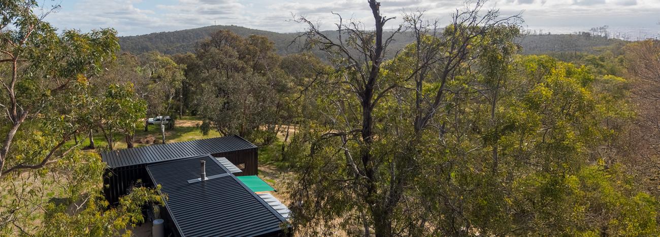 to LYSAGHT KLIP-LOK® 700 CLASSIC roofing and Half Round Guttering, made from COLORBOND® steel in Night Sky® at a property in Aireys Inlet, Victoria. 