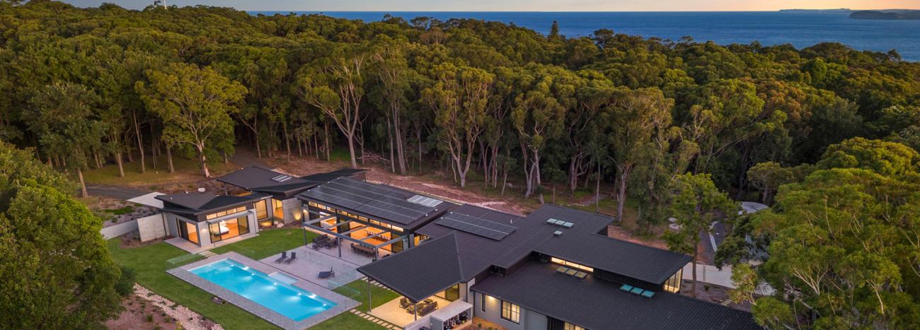 Contemporary coastal home with steel cyclone roofing designed for high wind regions