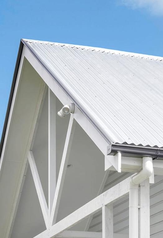 Queenslander building with custom orb roofing in zincalume finish