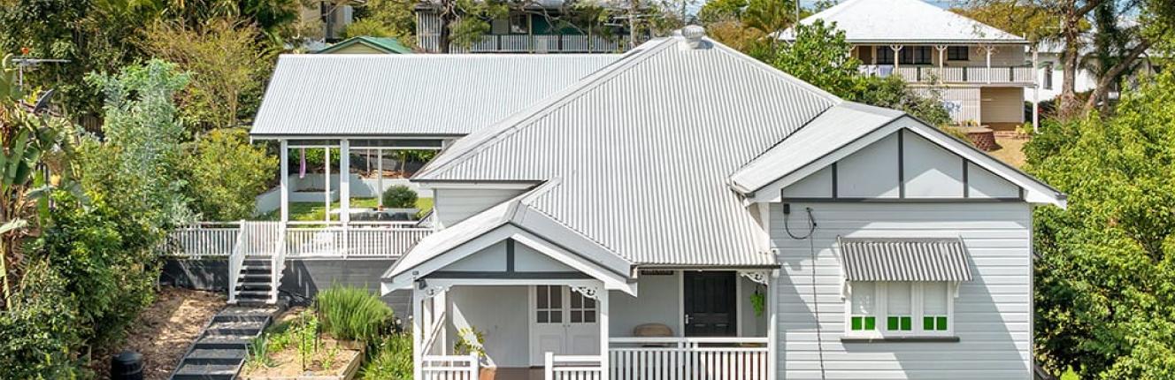 Queenslander style house with custom orb roofing in zincalume finish