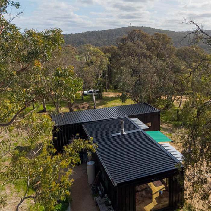 : Bushland modular home with low-pitched roof clad in LYSAGHT® metal roofing sheets for durability