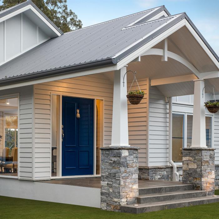 Hamptons-style home with gable roof finished in LYSAGHT® corrugated metal roofing sheets