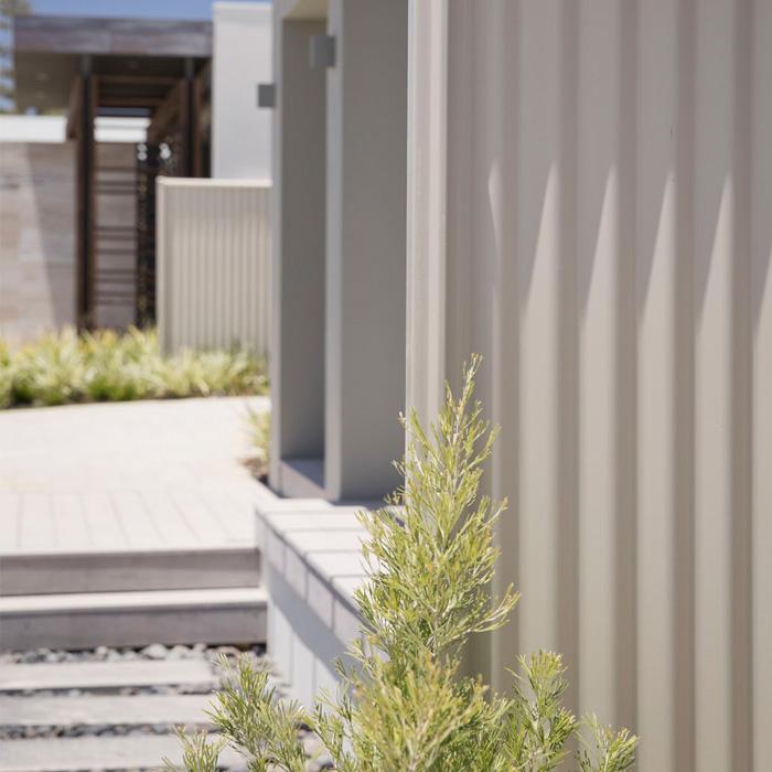 Steel cyclone fencing providing privacy and boundary strength in a modern home setting