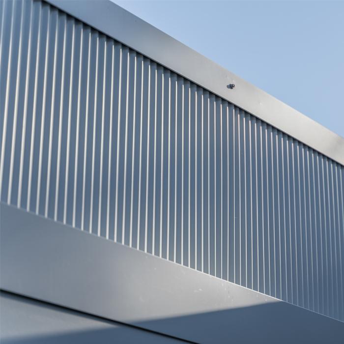 : Close-up of vertical MINI ORB® cladding panels, showing fine corrugation used for modern wall cladding.