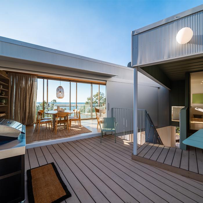 Courtyard and deck with exterior wall cladding, featuring MINI ORB® cladding used to define outdoor living spaces.