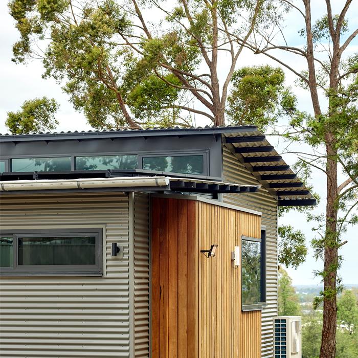 Contemporary home with corrugated MINI ORB® cladding paired with timber, showing layered exterior cladding design.