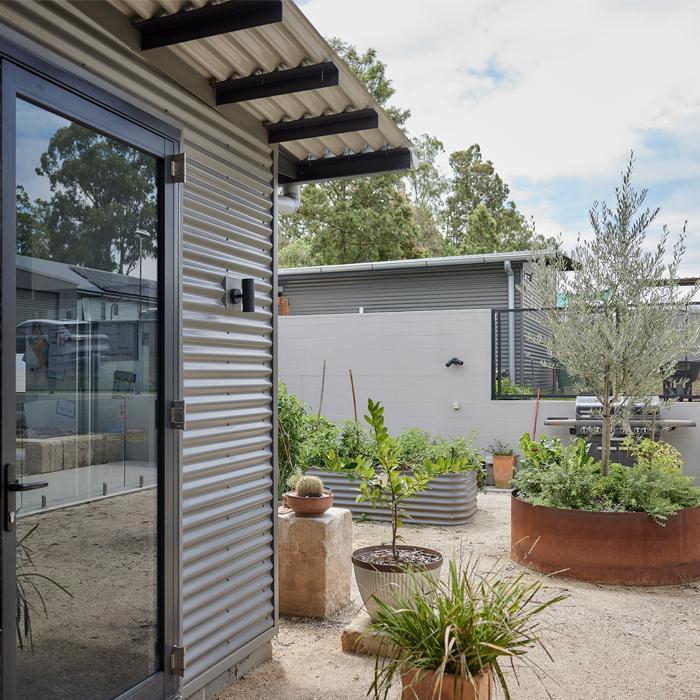 Garden studio with MINI ORB® wall cladding, illustrating corrugated cladding used as a durable exterior feature wall.