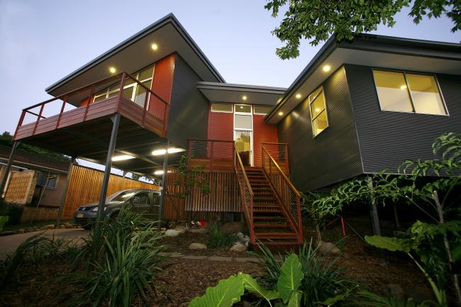 House with MINI ORB steel walling manufactured from COLORBOND steel in colours Woodland Grey and Manor Red